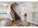 Bright entryway with hardwood floors and a staircase leading to the upper level at 6605 Pemberton Sage Ct, Seffner, FL 33584