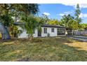 Newly renovated home with a white exterior, dark-grey accents and a carport at 2504 38Th W Ave, Bradenton, FL 34205