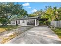 Newly renovated home with a white exterior, dark-grey accents and a carport at 2504 38Th W Ave, Bradenton, FL 34205