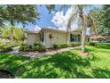 Single-story villa with a yellow exterior, blue shutters, and a well-maintained lawn at 2346 Nantucket Dr # 58, Sun City Center, FL 33573