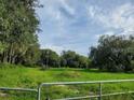 Vacant lot with grassy field and perimeter fence at 10510 Sumner Rd, Wimauma, FL 33598