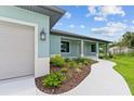 Front view of the house with a walkway and landscaping at 9171 Prospect Ave, Englewood, FL 34224