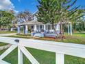 Blue house with a wrap-around porch and white picket fence at 510 Tighe Ave, Seffner, FL 33584