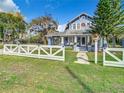 Quaint blue house with a wrap-around porch and white picket fence at 510 Tighe Ave, Seffner, FL 33584