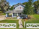 Charming blue house with a wrap-around porch and white picket fence at 510 Tighe Ave, Seffner, FL 33584