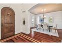 Inviting dining room with hardwood floors, arched doorway, and modern chandelier at 4108 W San Luis St, Tampa, FL 33629