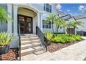 Inviting home exterior with double doors, lush landscaping, and a stone walkway at 5013 W Leona St, Tampa, FL 33629