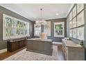 Elegant home office featuring a large desk, hardwood floors, and natural light at 5013 W Leona St, Tampa, FL 33629
