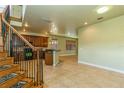 Open floor plan with tile floors and a wooden staircase at 10426 La Mirage Ct, Tampa, FL 33615
