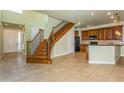 Open concept living space with kitchen and staircase views at 10426 La Mirage Ct, Tampa, FL 33615