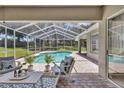 Inviting screened pool area with patio furniture at 805 Woodcarver Ln, Brandon, FL 33510