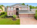 Large two-story house with a spacious yard and brick driveway at 21631 Cormorant Cove Dr, Land O Lakes, FL 34637