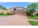 Two-story house with a two-car garage and manicured lawn at 21631 Cormorant Cove Dr, Land O Lakes, FL 34637