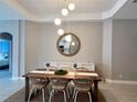 Elegant dining room with a large wooden table and mirror at 4801 Cypress Club Pl, Tampa, FL 33624