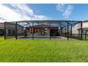 Screened-in pool with flags and backyard at 3504 Big Sky Way, Bradenton, FL 34211