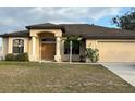 One-story home with a beige exterior, brown roof, and attached garage at 4458 Maverick St, North Port, FL 34288