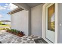 Inviting entryway featuring a decorative glass door and stylish pavers leading to the entrance at 9421 Ballaster Pointe Loop, Parrish, FL 34219