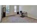 Spacious home office with carpeted floor and large windows at 16321 Treasure Point Dr, Wimauma, FL 33598