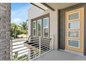 Balcony view featuring a modern railing and a bright yellow door at 2509 N Glenwood Dr, Tampa, FL 33602