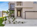 View of the exterior showing landscaping and a modern front door at 2509 N Glenwood Dr, Tampa, FL 33602