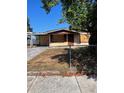 Fixer-upper home with boarded windows and chain-link fence at 10007 N 26Th St, Tampa, FL 33612