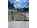 Backyard with chain-link fence, shed, and carport at 10007 N 26Th St, Tampa, FL 33612