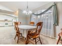 Cozy dining area with wood table and chairs, adjacent to kitchen at 6928 Stephens Path, Zephyrhills, FL 33542