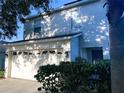 Two-story house with a two-car garage and landscaping at 3316 Thistledown Ln, Land O Lakes, FL 34638