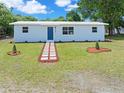 Newly renovated single story home featuring a modern exterior and a manicured lawn at 801 Brodhag Dr, Punta Gorda, FL 33950