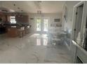 Open concept kitchen with marble floors and modern appliances at 10520 Henderson Rd, Tampa, FL 33625