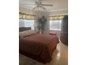 Bedroom with double bed, ceiling fan, and dresser at 90 144Th Ave # 7, Madeira Beach, FL 33708