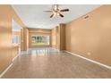 Living room with tile floors and a view to the kitchen at 28405 Tall Grass Dr, Wesley Chapel, FL 33543