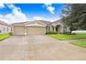 Two-story house with a two-car garage and driveway at 5753 Wynstone Ln, Zephyrhills, FL 33541