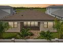 A spacious backyard has sliding glass doors and a manicured lawn at 8320 Golden Beach Ct, Parrish, FL 34219