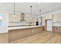 Modern kitchen with island and stainless steel appliances at 8320 Golden Beach Ct, Parrish, FL 34219