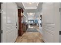 Grand entrance into the open-concept living area with tiled floors and a gorgeous chandelier at 16300 Gulf Blvd # 300B, Redington Beach, FL 33708
