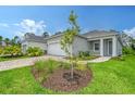 One-story home with gray exterior, two-car garage, and landscaped yard at 18337 Vizcaya Ct, Venice, FL 34293