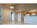 Bright living room with an open layout, tile floors, and a view of the kitchen at 5125 Palm Springs Blvd # 1303, Tampa, FL 33647