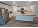 Bright kitchen featuring an island with a sink, granite countertops, and stainless steel appliances at 3769 S Haberland Blvd, North Port, FL 34288