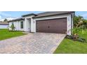 Modern home's exterior boasts a two-car garage and a landscaped front yard at 4196 Sea Horse Ave, North Port, FL 34286