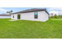 Large backyard with grassy area and patio at 5307 Burgner St, Port Charlotte, FL 33981