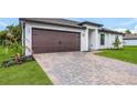 House exterior with a brown garage door and paved driveway at 5307 Burgner St, Port Charlotte, FL 33981
