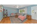 Living room with light beige sectional sofa and wood floors at 1402 Viscaya Dr, Port Charlotte, FL 33952