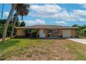 Single story home with attached garage and palm trees at 1402 Viscaya Dr, Port Charlotte, FL 33952