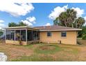 Backyard view of screened patio and home at 1402 Viscaya Dr, Port Charlotte, FL 33952