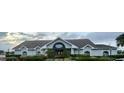 Front exterior view of community center featuring manicured landscaping and ample parking at 10957 Keys Gate Dr, Riverview, FL 33579