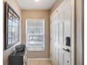 Bright entryway with white door, window blinds and a Beatles themed decor at 10957 Keys Gate Dr, Riverview, FL 33579