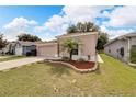 One-story house with a two-car garage, palm tree, and manicured lawn at 803 Parsons Pointe St, Seffner, FL 33584