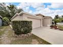 One-story house with a two-car garage and neatly trimmed hedges at 803 Parsons Pointe St, Seffner, FL 33584