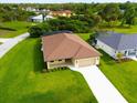 An aerial view showcasing a house with a brown roof and a large backyard at 9187 Prospect Ave, Englewood, FL 34224